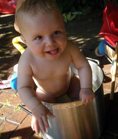 Baby playing in a bucket 